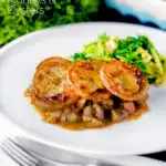 Traditional scalloped potato topped Lancashire hotpot with buttered cabbage on a plate featuring a title overlay.