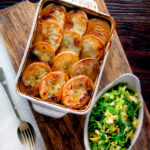 Overhead scalloped potato topped Lancashire hotpot with buttered cabbage.
