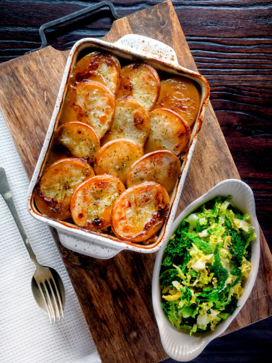 Overhead scalloped potato topped Lancashire hotpot with buttered cabbage.