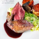 Close-up roast pigeon crown, confit legs, red wine sauce, cabbage and fondant potatoes featuring a title overlay.