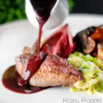 Red wine sauce poured over roast pigeon breast served with cabbage featuring a title overlay.