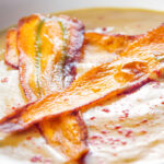 Close up parsnip soup with paprika and carrot.