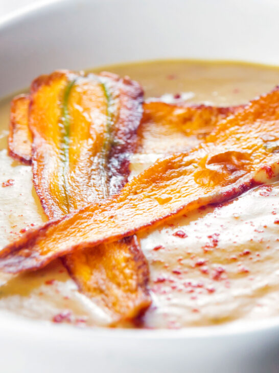 Close up parsnip soup with paprika and carrot.