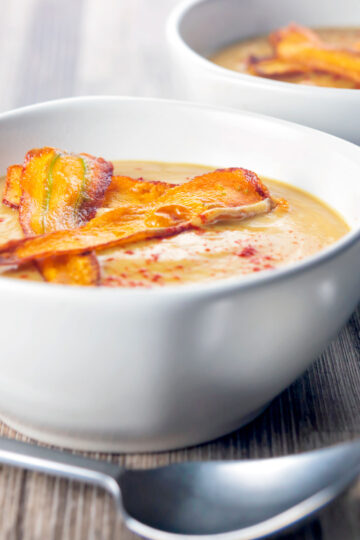 Roasted curried parsnip soup with paprika and crispy fried carrot strips.