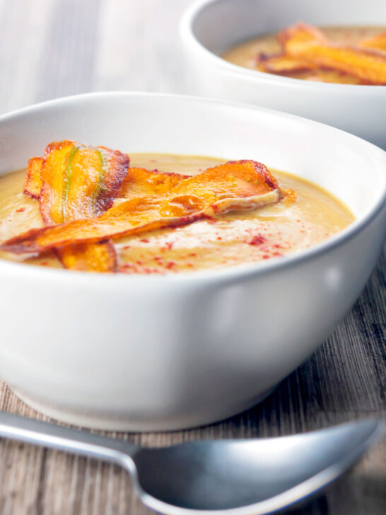 Roasted curried parsnip soup with paprika and crispy fried carrot strips.