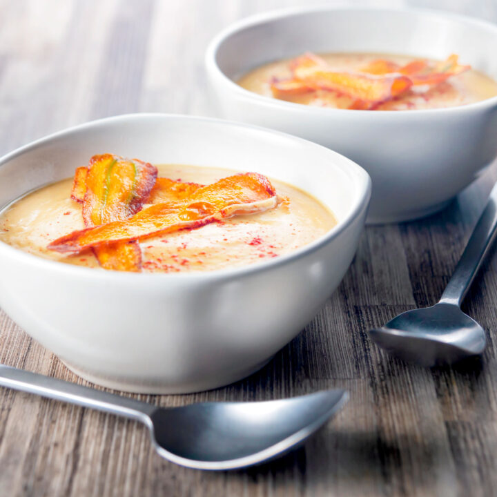 Roasted curried parsnip soup with paprika and fried carrot crisps.