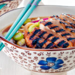 Spicy pork ramen soup with spring onions.