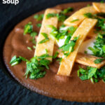 Close-up spicy vegan black bean soup with Mexican influences featuring a title overlay.