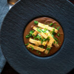 Overhead spicy vegan black bean soup with Mexican influences.
