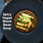 Overhead spicy vegan black bean soup with Mexican influences featuring a title overlay.