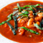 Close-up slow cooker bean and tomato soup with balsamic vinegar.