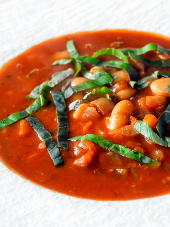 Close-up slow cooker bean and tomato soup with balsamic vinegar.