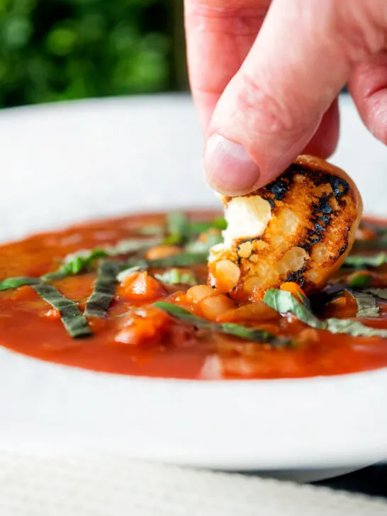 Toasted bread dipped into crockpot bean and tomato soup.