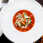 Overhead slow cooker bean and tomato soup with balsamic vinegar.