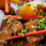 Close-up Pakistani aloo gosht meat and potato curry.