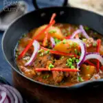 Pakistani aloo gosht meat and potato curry served with a naan bread featuring a title overlay.