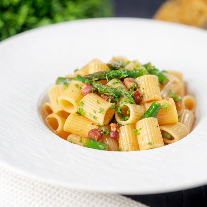 Garlicky bacon and asparagus pasta with mezzi rigatoni and fresh parsley.