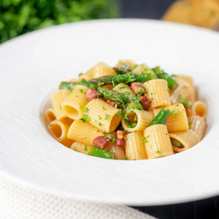 Garlicky bacon and asparagus pasta with mezzi rigatoni and fresh parsley.