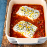 Baked cod with tomato sauce served with green bean amandine.
