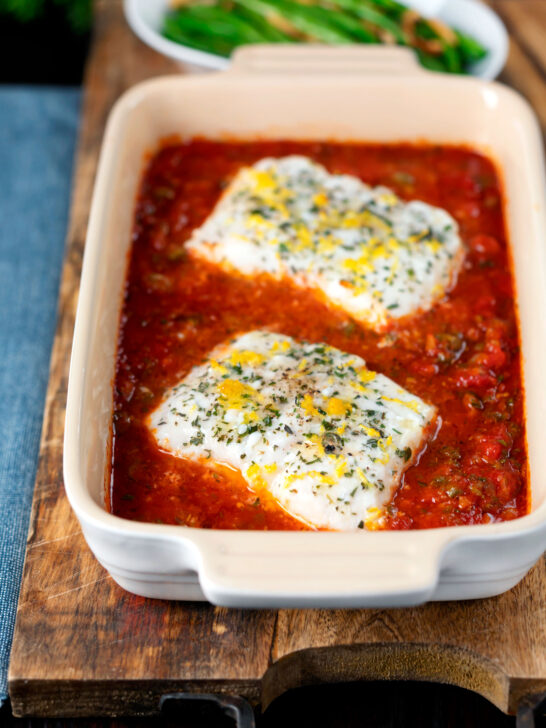 Baked cod with tomato sauce served with green bean amandine.