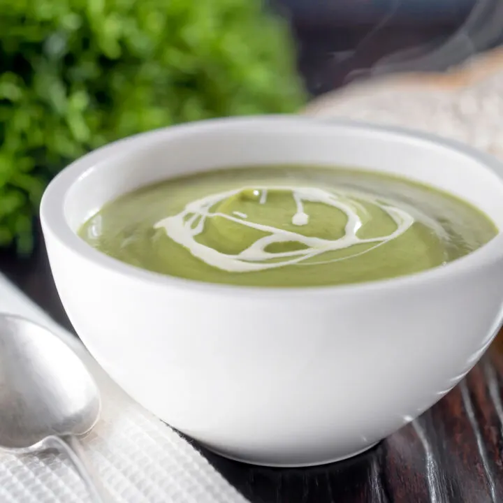 Steaming hot bowl of British broccoli and stilton soup with a swirl of cream.