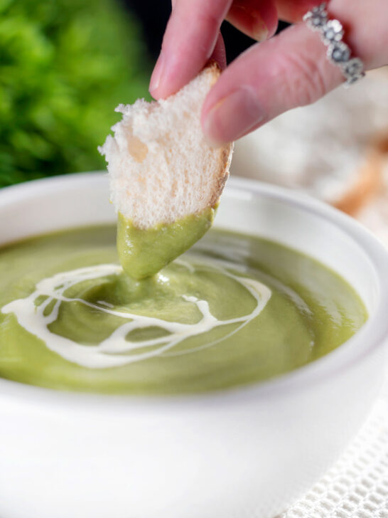 Crusty bread dipped into creamy broccoli and stilton soup.