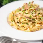 Chicken and mushroom tagliatelle with fresh chives featuring a title overlay.