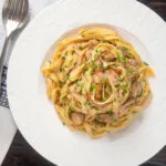 Overhead chicken and mushroom tagliatelle with fresh chives.