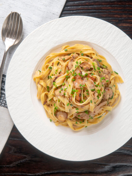 Overhead chicken and mushroom tagliatelle with fresh chives.