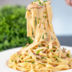Easy chicken and mushrooom tagliatelle pasta being eaten by a fork.