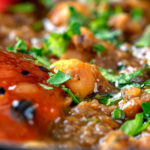 Close-up Indian-inspired chickpea and lentil curry with kachumber salad and mango chutney.