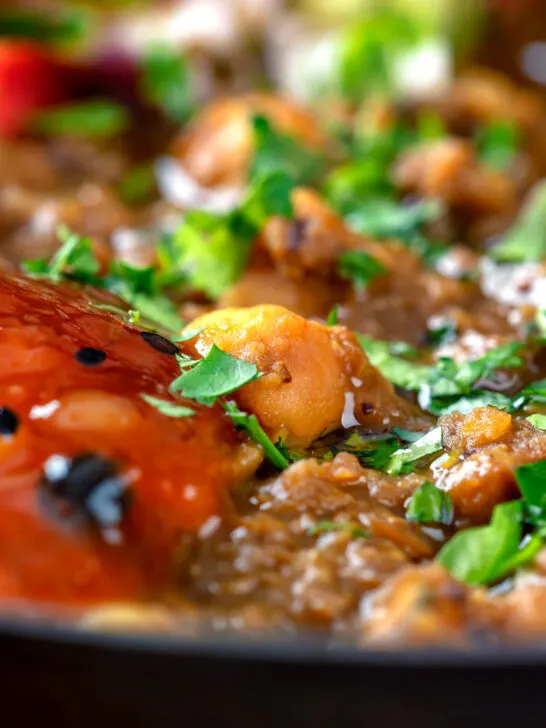 Close-up Indian-inspired chickpea and lentil curry with kachumber salad and mango chutney.