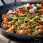 Indian-inspired chickpea and lentil curry with kachumber salad and mango chutney featuring a title overlay.