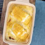 Overhead cod mornay with a breadcrumb topping in a baking dish.