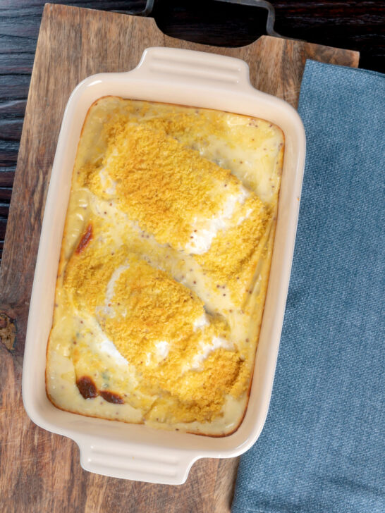 Overhead cod mornay with a breadcrumb topping in a baking dish.