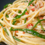 Close-up crab linguine pasta with chilli and samphire featuring a title overlay.