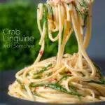 Crab linguine with chilli and samphire being picked up with a fork featuring a title overlay.