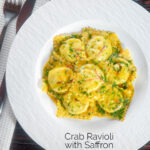 Overhead crab and ricotta ravioli with a saffron and dill butter sauce featuring a title overlay.