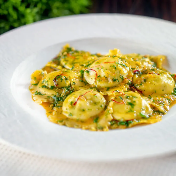 Crab and ricotta ravioli with a white wine, dill and saffron sauce.