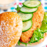 Close-up Crispy chicken breast fillet burger, cucumber and frisee lettuce.