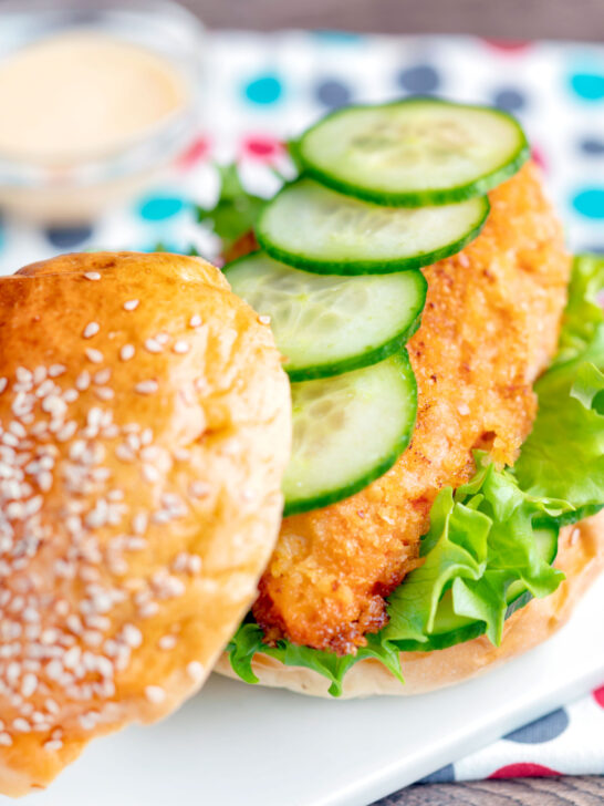 Close-up Crispy chicken breast fillet burger, cucumber and frisee lettuce.