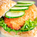 Crispy chicken breast fillet sandwich with cucumber and lettuce featuring a title overlay.