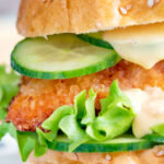 Close-up crispy chicken breast fillet sandwich with sweet chilli mayo.