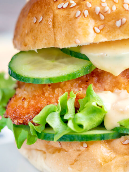 Close-up crispy chicken breast fillet sandwich with sweet chilli mayo.