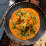 Overhead dum aloo baby potato curry with a tomato gravy.