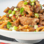 Chinese salt and pepper chicken served with noodles.