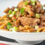 Chinese salt and pepper chicken served with noodles.