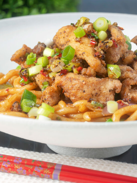Chinese salt and pepper chicken served with noodles.