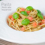 Pasta pesto alla trapanese with spaghetti, fresh tomato and basil featuring a title overlay.