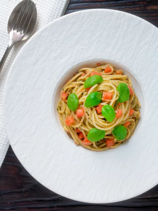 Overhead pasta pesto alla trapanese fresh tomato and basil.